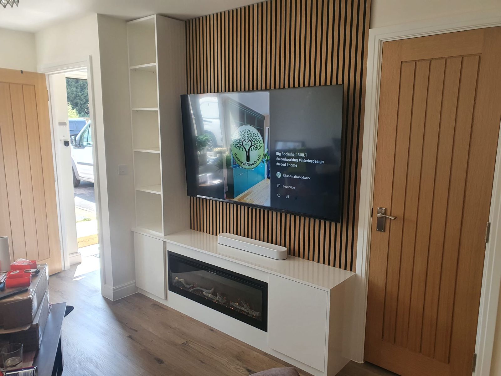 Fitted media wall with slat panel feature wall, floating cabinet and electric fire